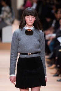crew-neck sweater with necklace or brooch